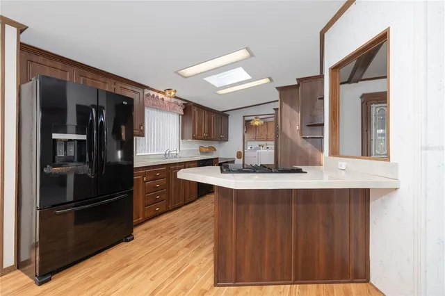 a kitchen with stainless steel appliances granite countertop a refrigerator and a sink