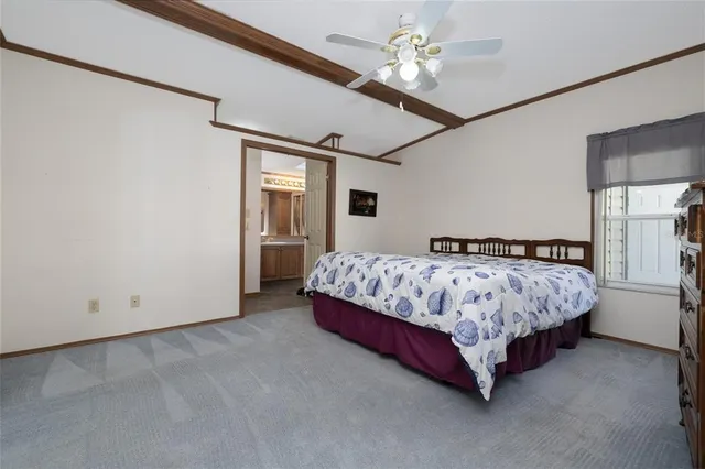 a spacious bedroom with a bed and a ceiling fan