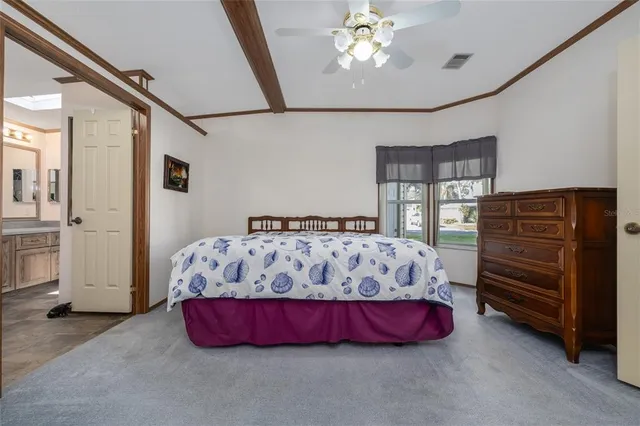 a bed sitting in a bedroom next to a window