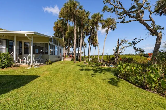 a view of a house with swimming pool and sitting area