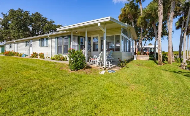a view of a house with pool and sitting area