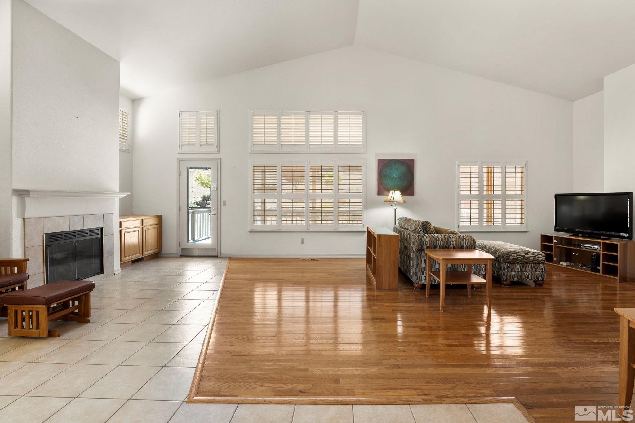 50 Deer Valley Court Reno, NV 89511 - Photo 11 of 39 a living room with fireplace furniture and a floor to ceiling window