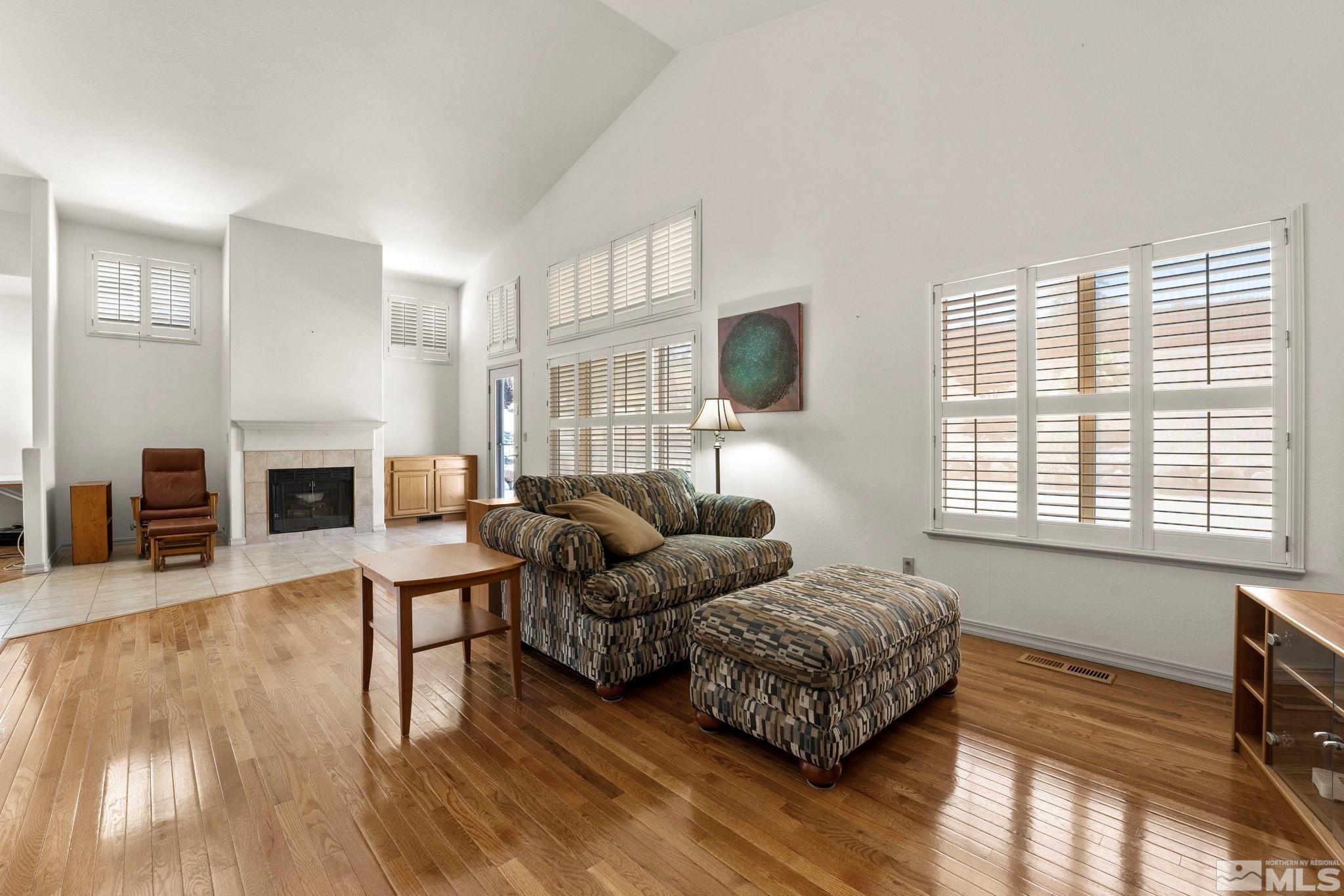 50 Deer Valley Court Reno, NV 89511 - Photo 13 of 39 a living room with furniture flat screen tv and a fireplace