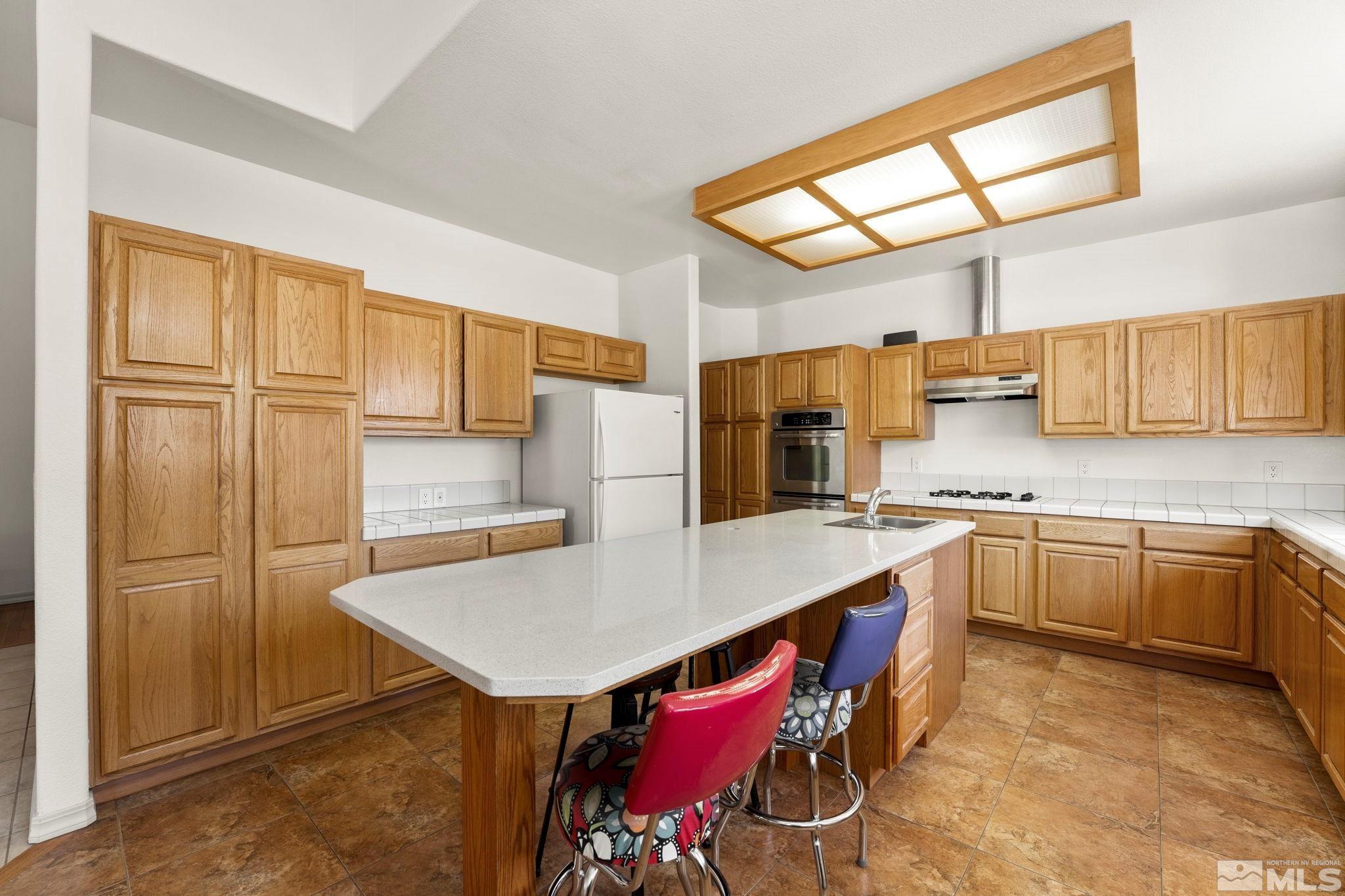 50 Deer Valley Court Reno, NV 89511 - Photo 15 of 39 a kitchen with stainless steel appliances a sink and cabinets