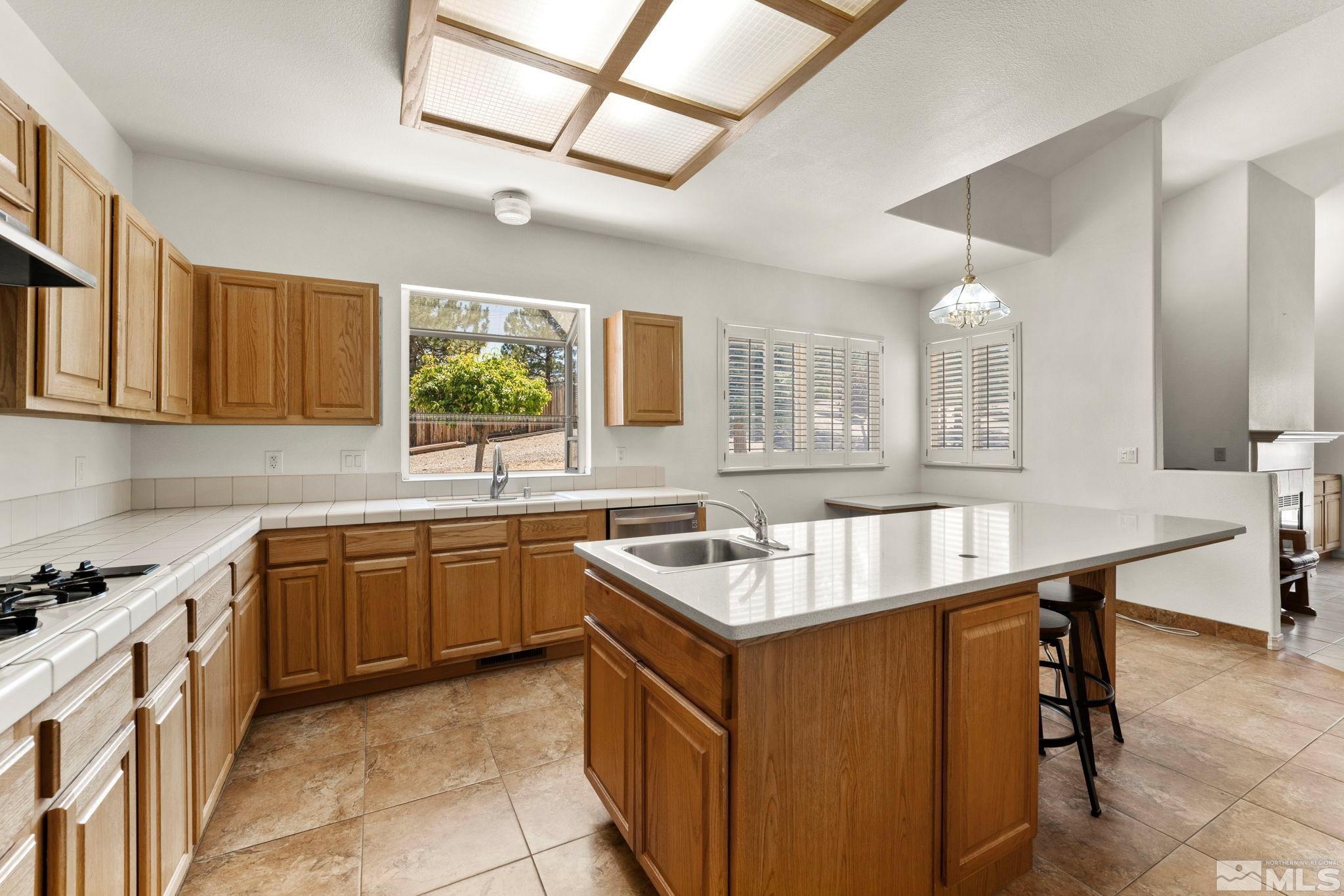 50 Deer Valley Court Reno, NV 89511 - Photo 16 of 39 a kitchen with a sink stove and cabinets