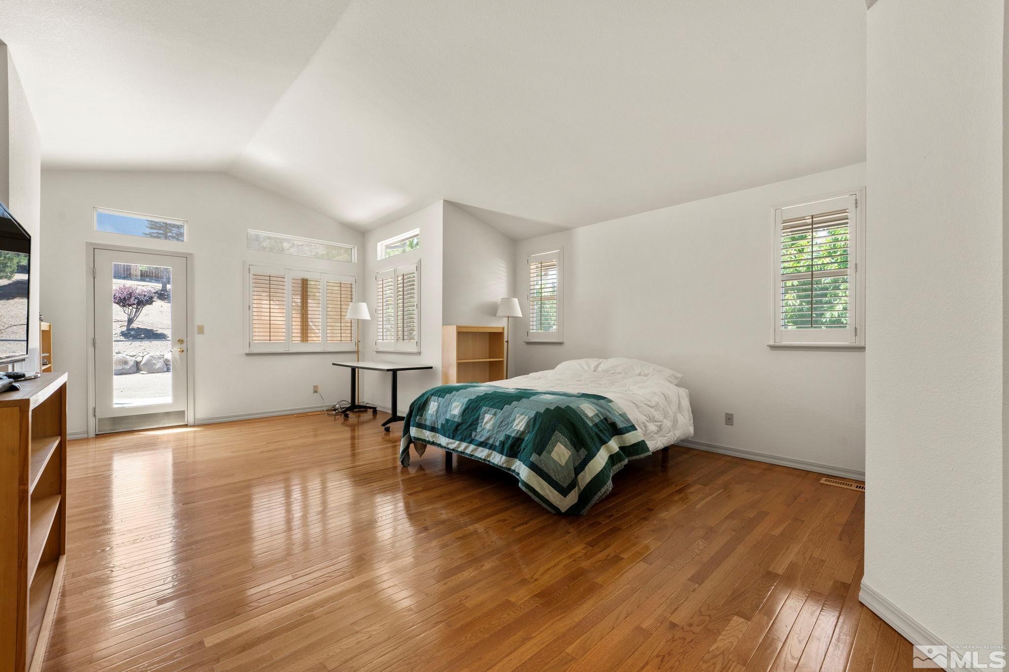 50 Deer Valley Court Reno, NV 89511 - Photo 17 of 39 a spacious bedroom with a bed a dresser and wooden floor