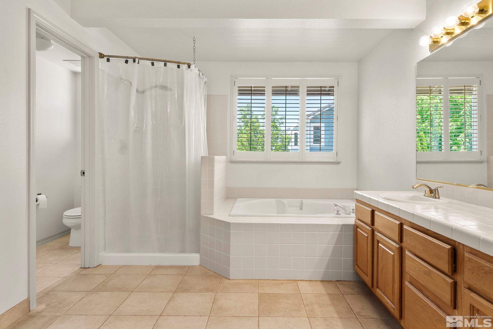 50 Deer Valley Court Reno, NV 89511 - Photo 19 of 39 a bathroom with a bathtub sink and toilet
