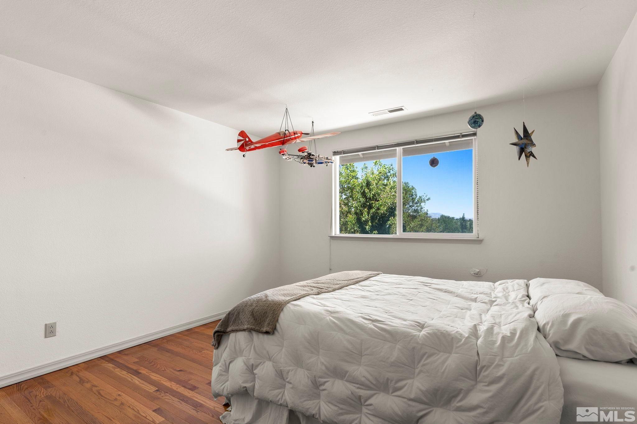 50 Deer Valley Court Reno, NV 89511 - Photo 21 of 39 a bedroom with a bed and a window