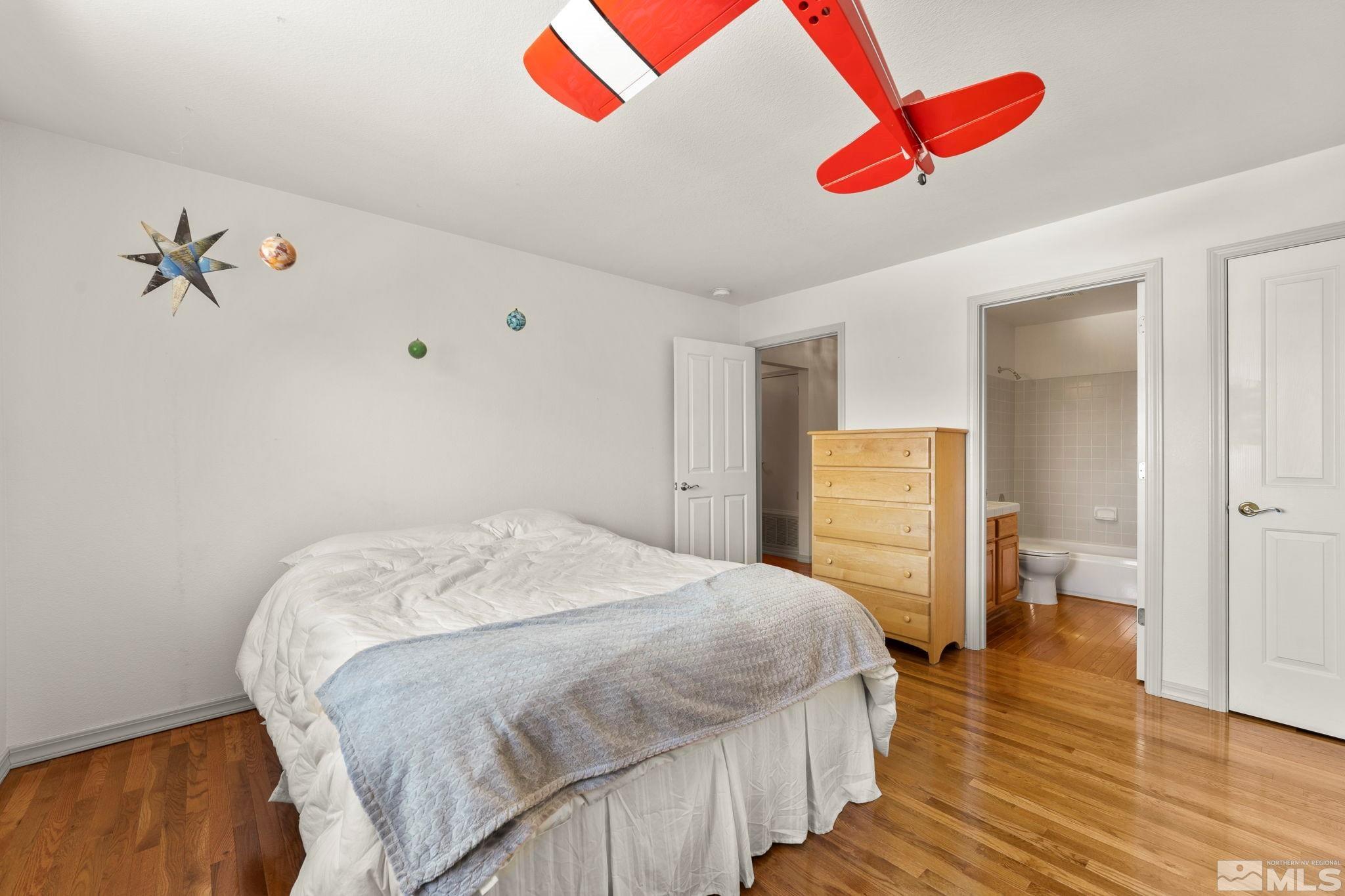 50 Deer Valley Court Reno, NV 89511 - Photo 22 of 39 a bedroom with a bed and a chandelier