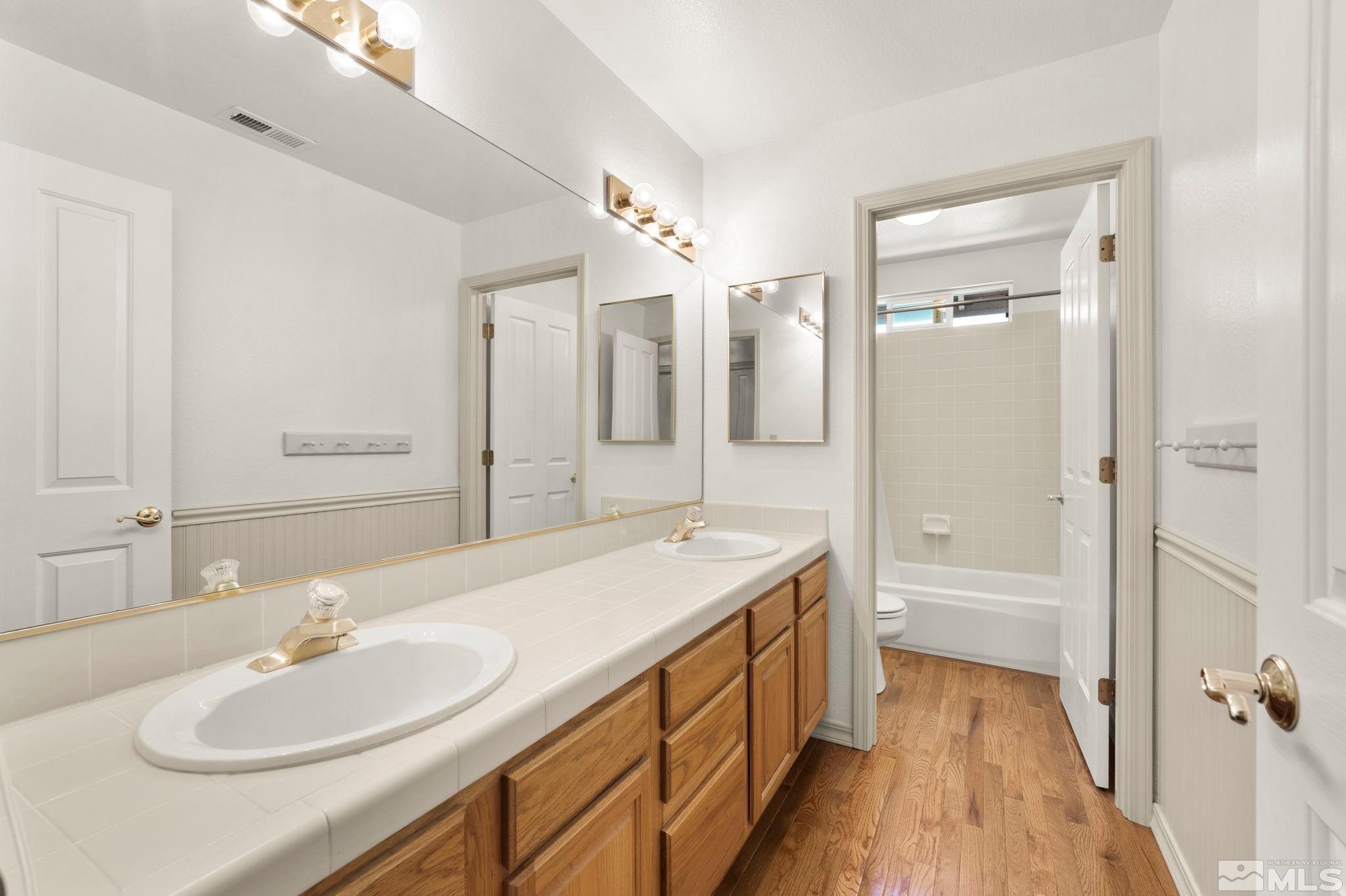 50 Deer Valley Court Reno, NV 89511 - Photo 23 of 39 a bathroom with a sink double vanity granite tub shower and a mirror