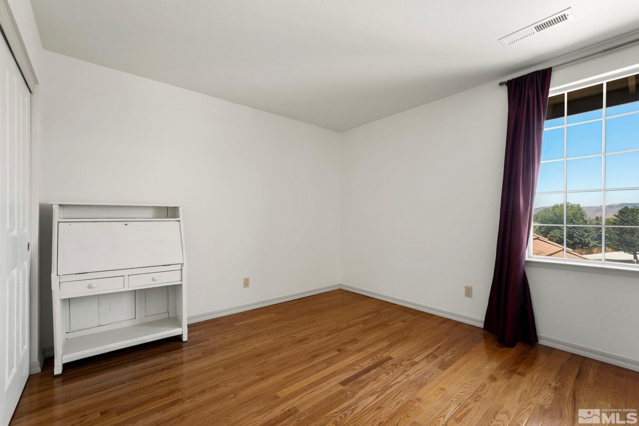 50 Deer Valley Court Reno, NV 89511 - Photo 24 of 39 a view of an empty room with wooden floor and a window