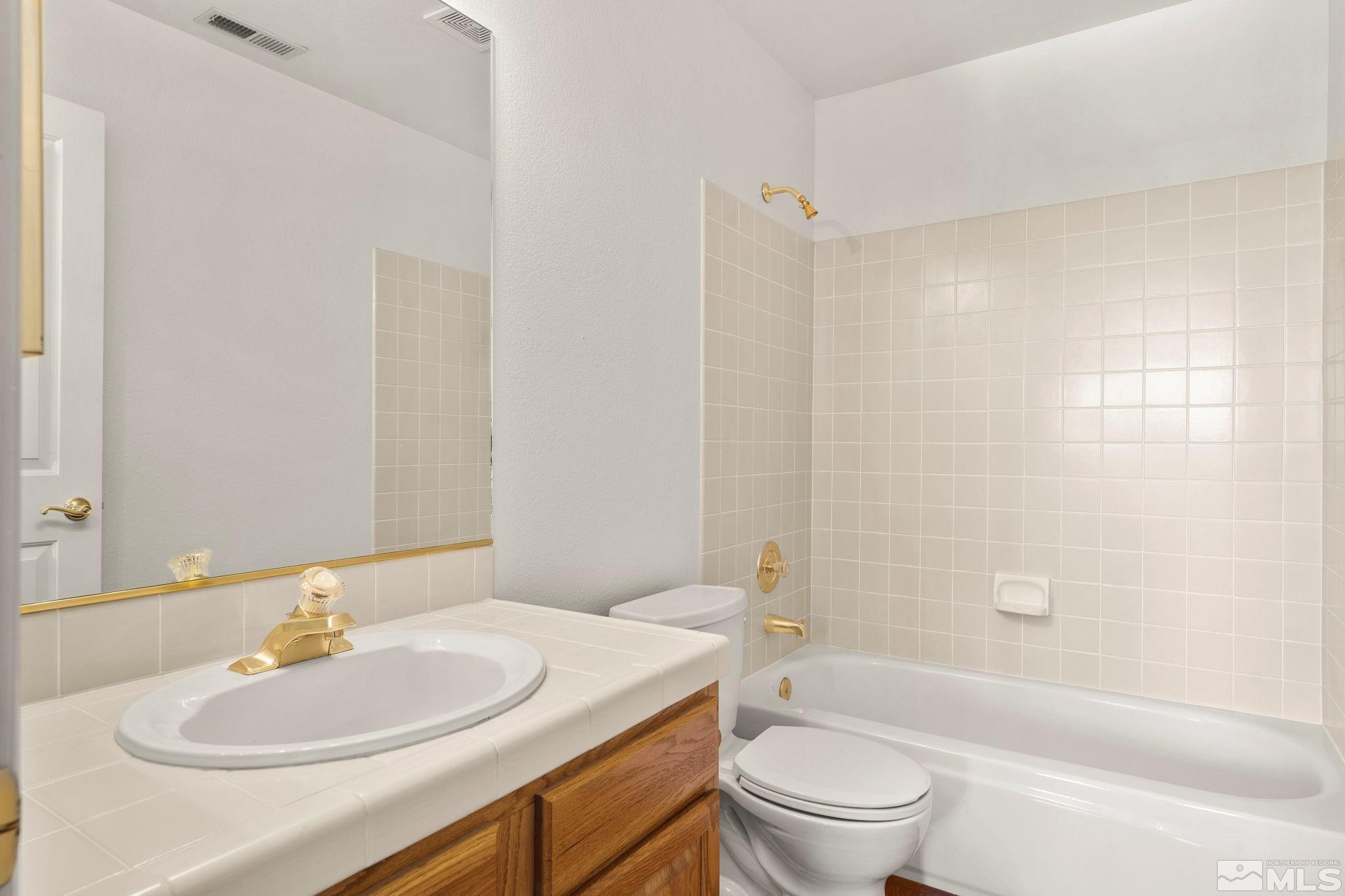 50 Deer Valley Court Reno, NV 89511 - Photo 26 of 39 a bathroom with a sink a toilet and shower