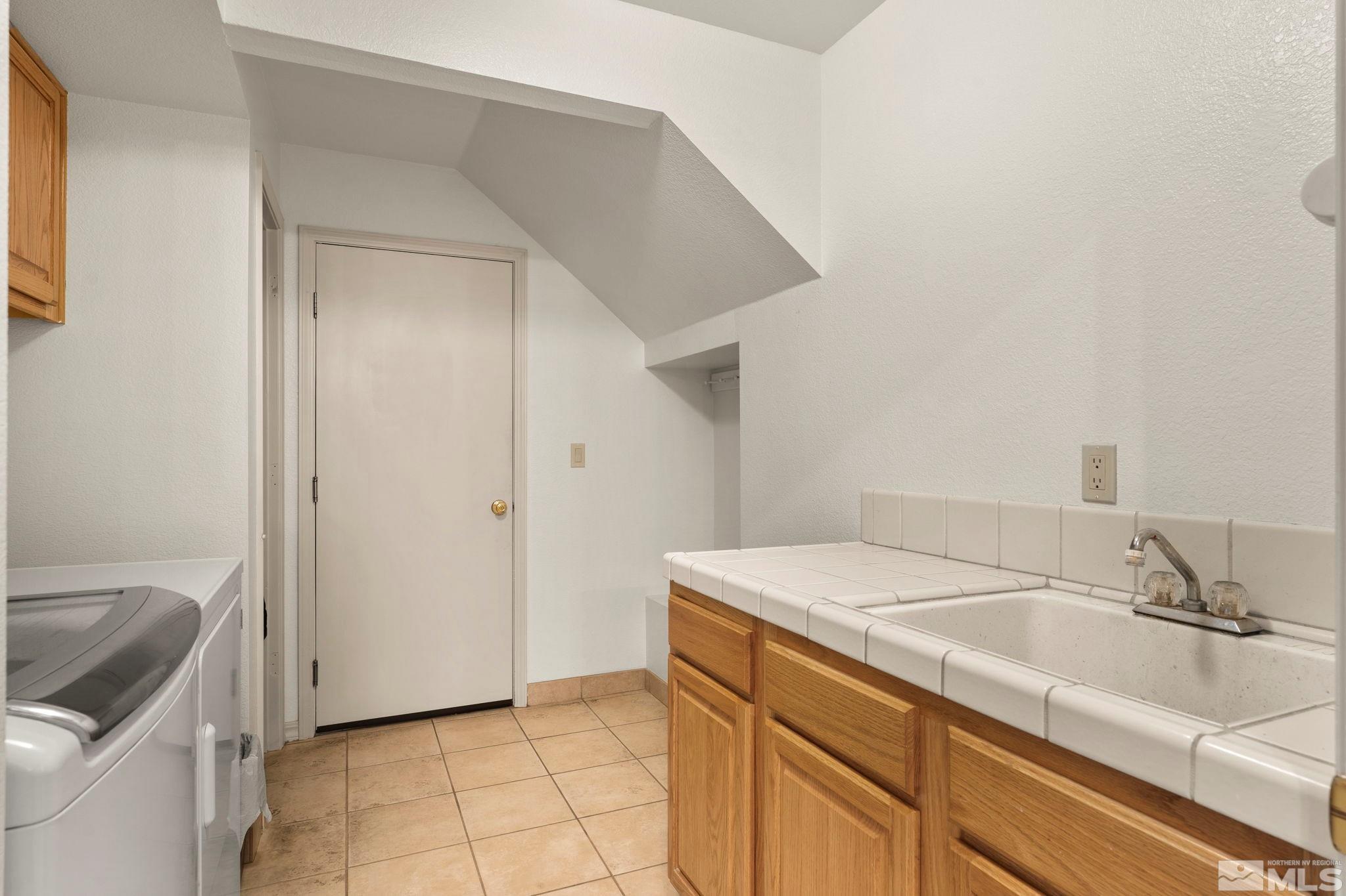 50 Deer Valley Court Reno, NV 89511 - Photo 27 of 39 a bathroom with a sink and a vanity