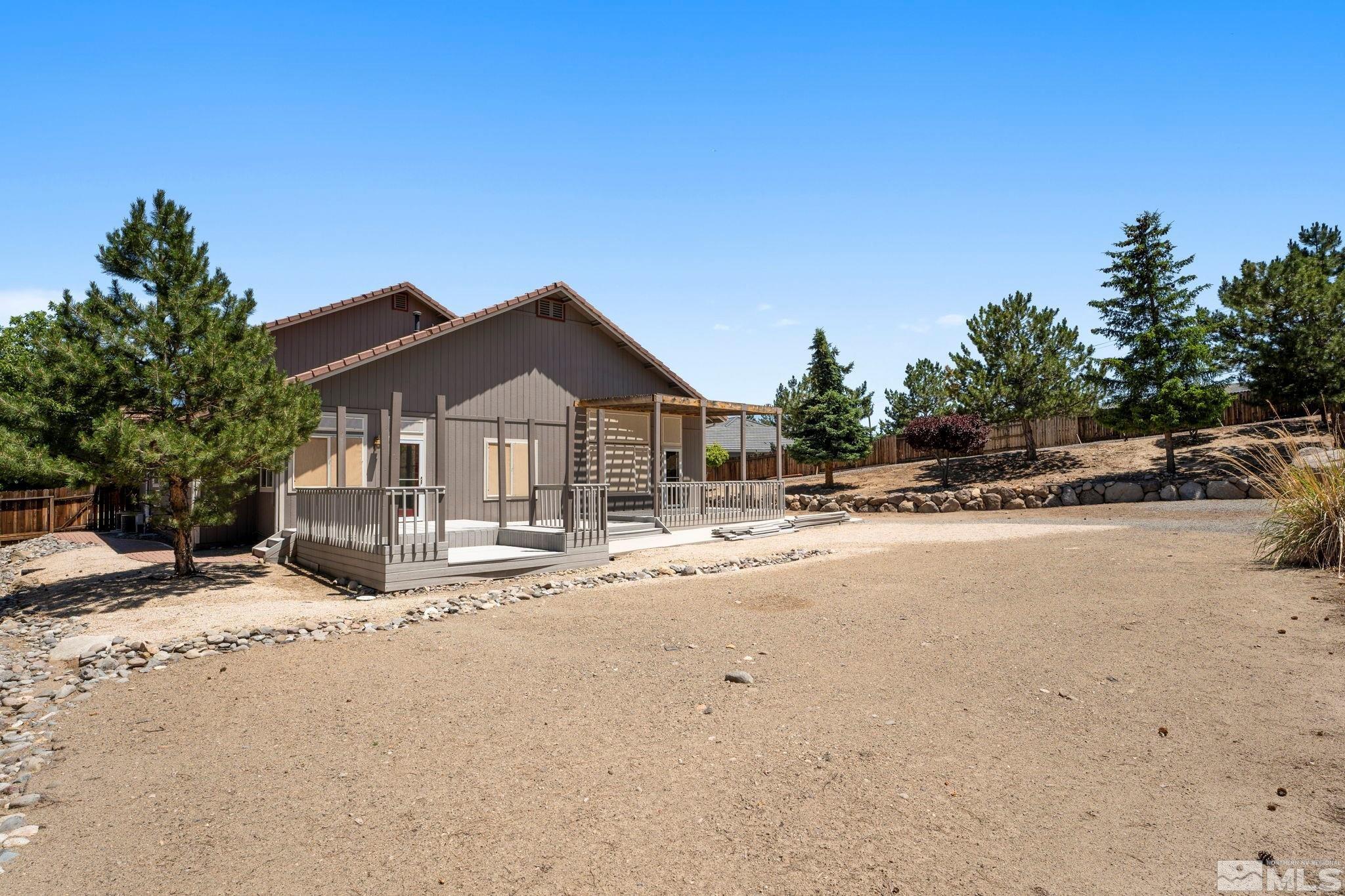 50 Deer Valley Court Reno, NV 89511 - Photo 32 of 39 a view of a house with wooden fence and large trees