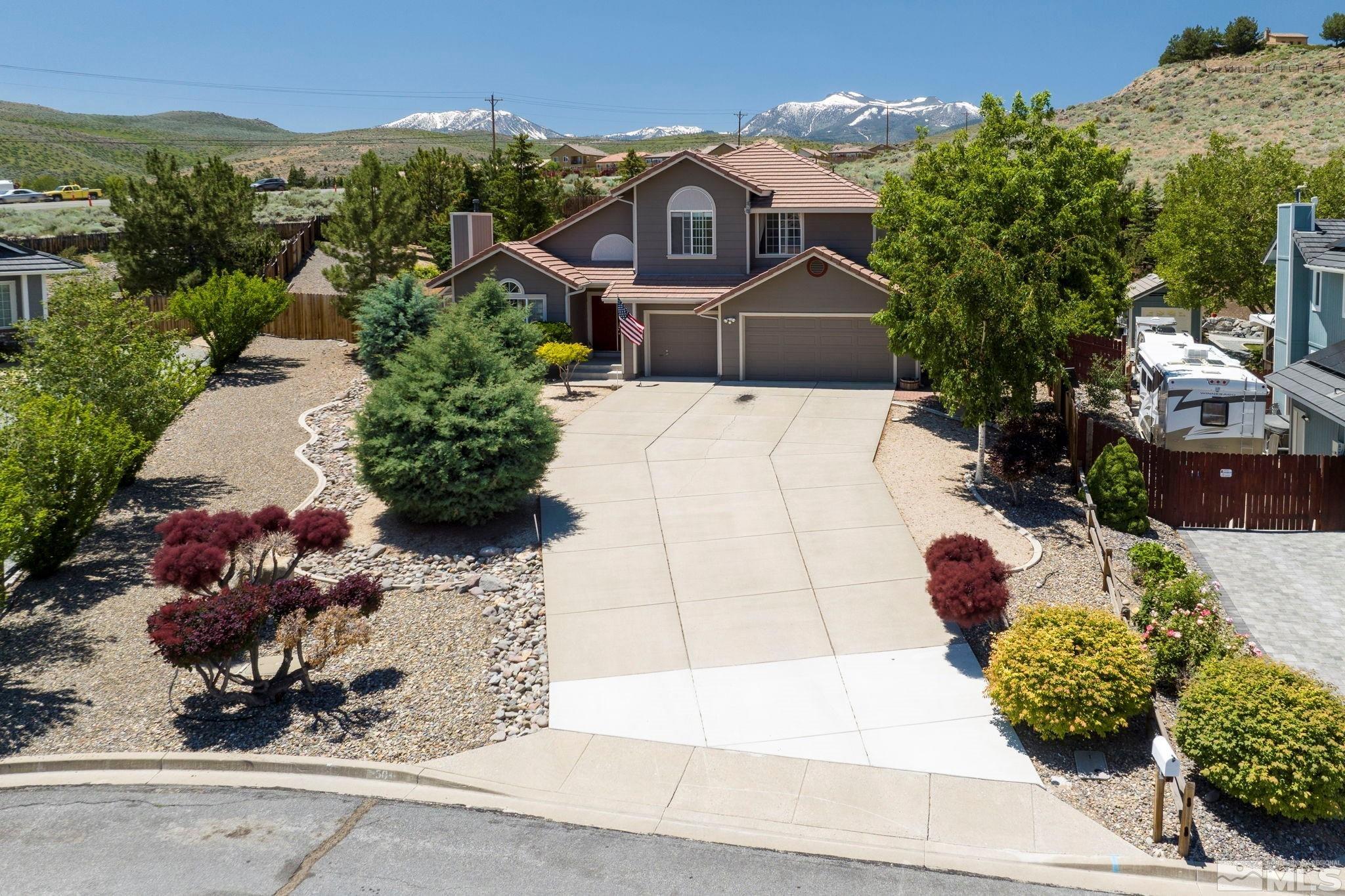 50 Deer Valley Court Reno, NV 89511 - Photo 4 of 39 a front view of a house with a yard and a pond