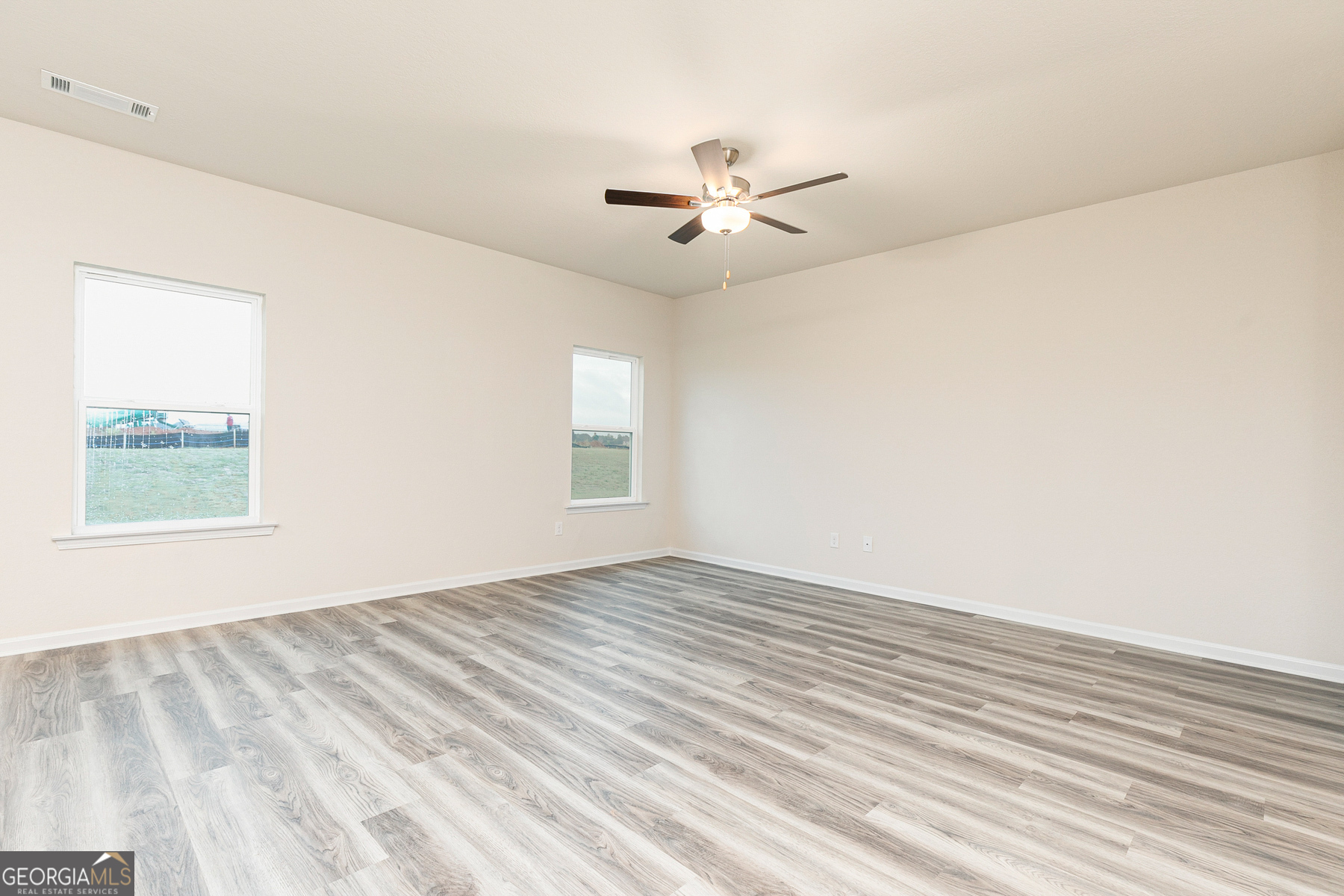 284 Limestone Circle Conyers, GA 30013 - Photo 13 of 25 an empty room with windows and fan