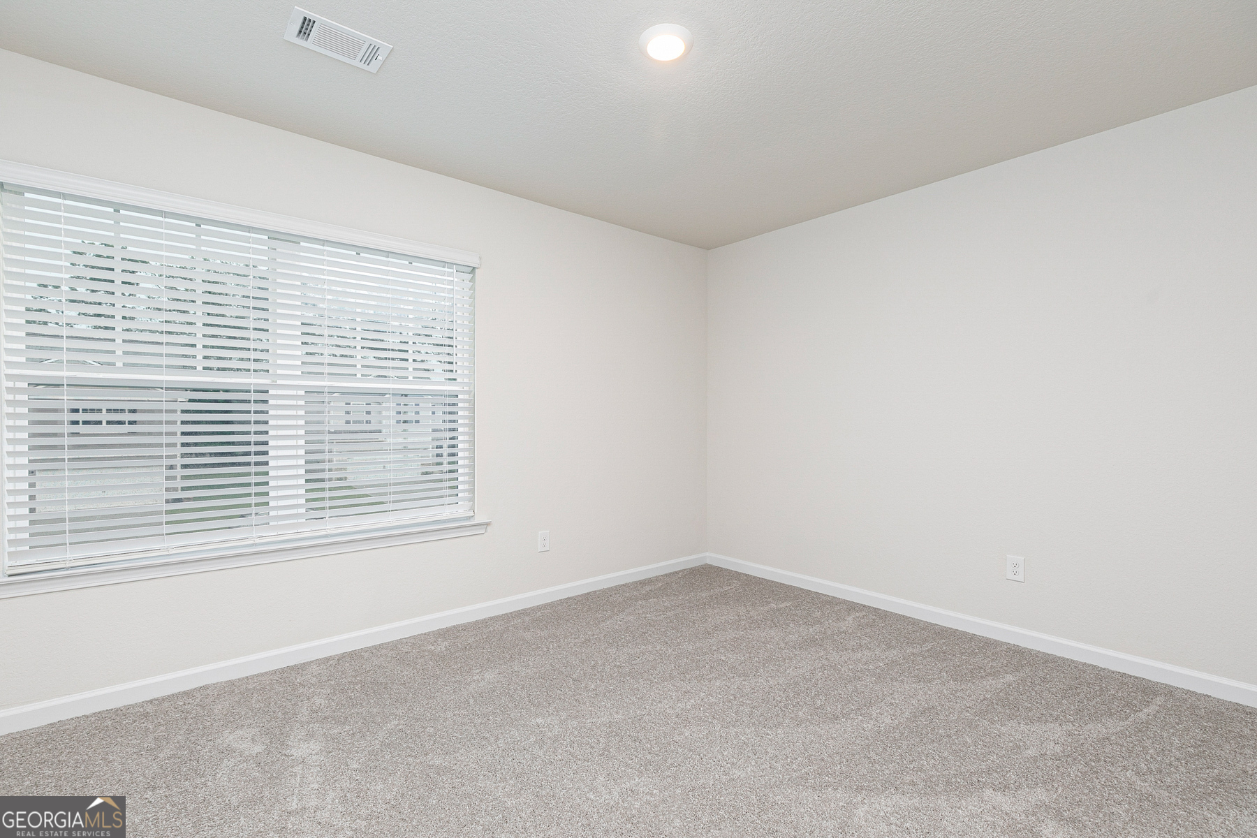 284 Limestone Circle Conyers, GA 30013 - Photo 23 of 25 an empty room with a window