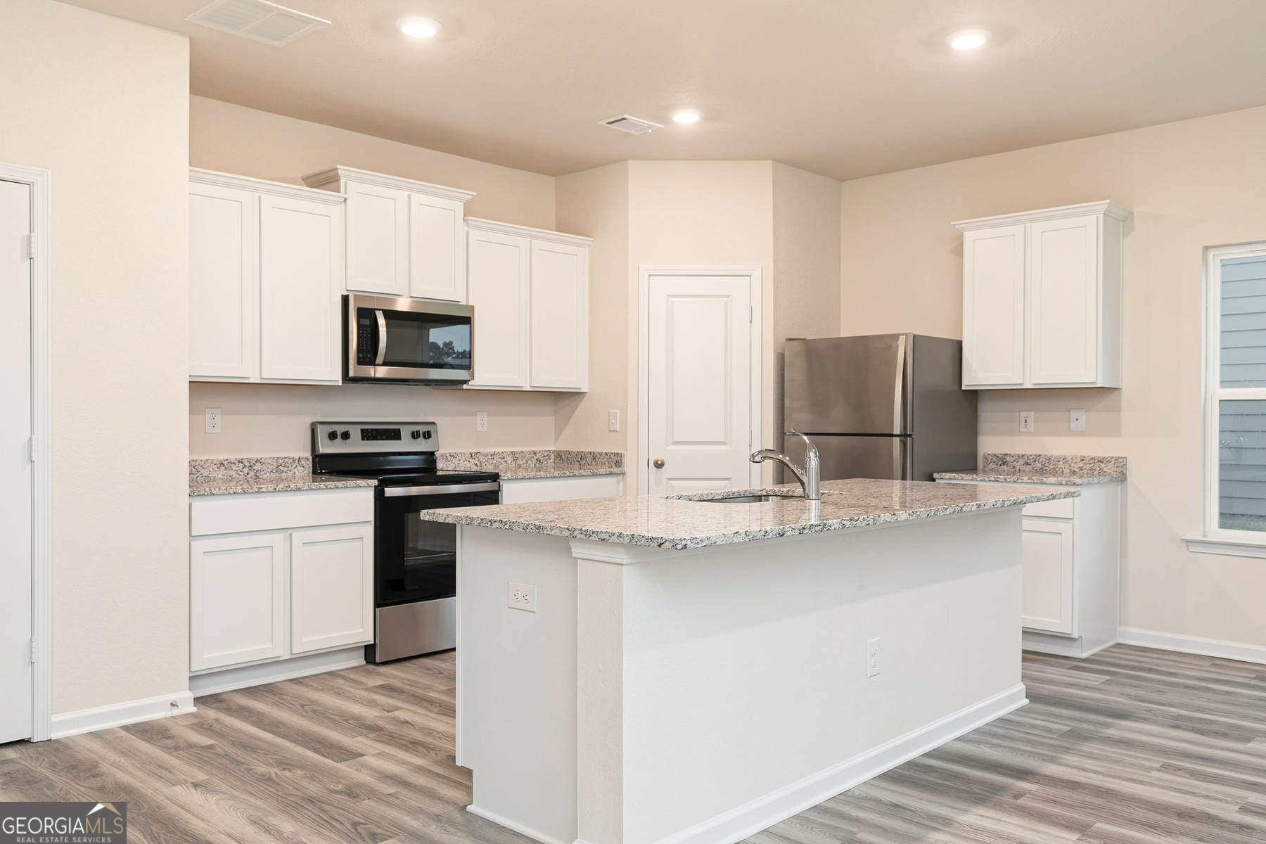 284 Limestone Circle Conyers, GA 30013 - Photo 7 of 25 a kitchen with appliances a sink and a counter top space