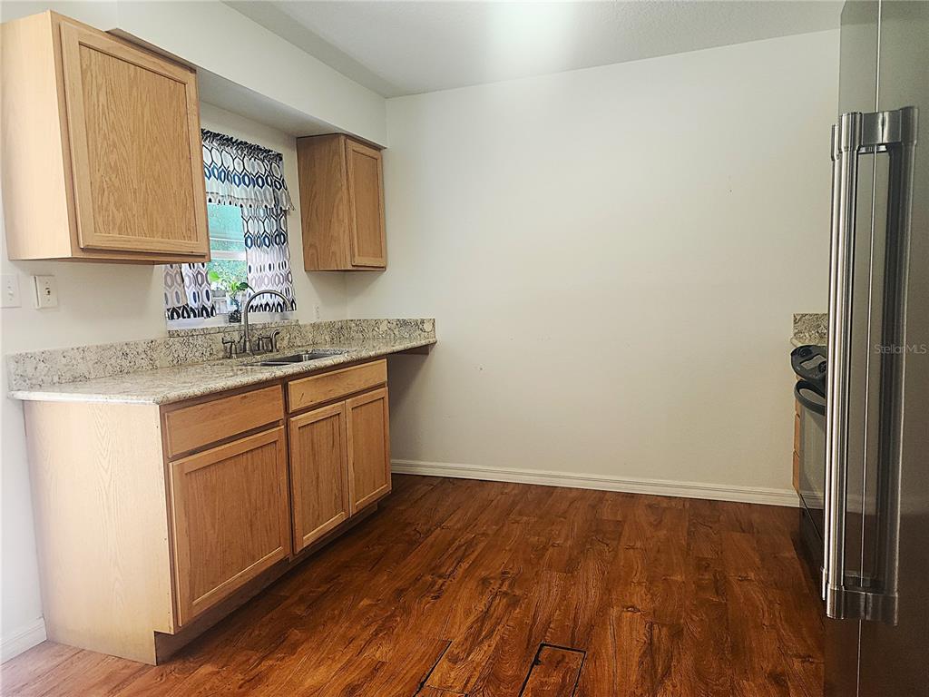 63 Estrella Road DeBary, FL 32713 - Photo 11 of 50 a kitchen with a sink wooden floor and cabinets