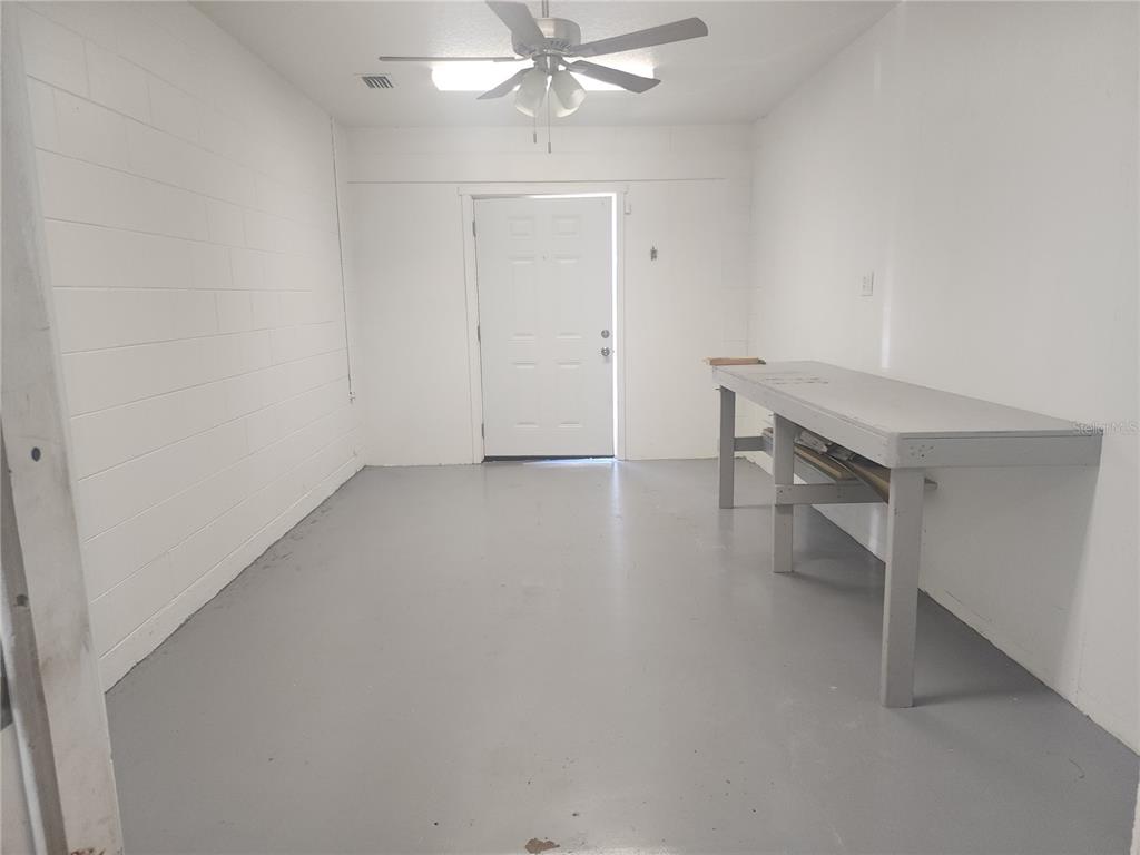 63 Estrella Road DeBary, FL 32713 - Photo 15 of 50 an empty room with a ceiling fan and wooden floor