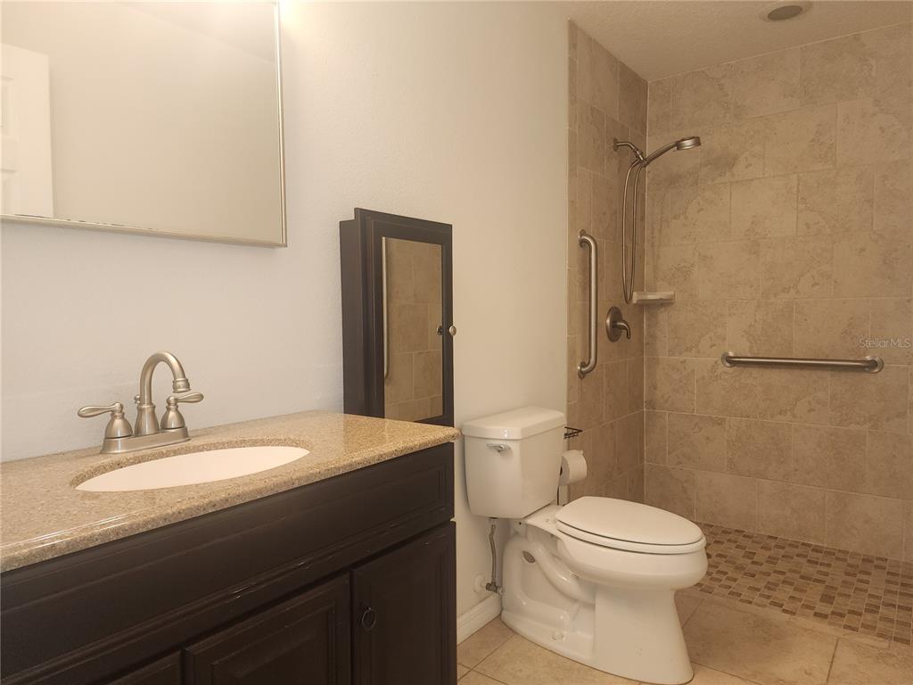 63 Estrella Road DeBary, FL 32713 - Photo 19 of 50 a bathroom with a sink a toilet and shower