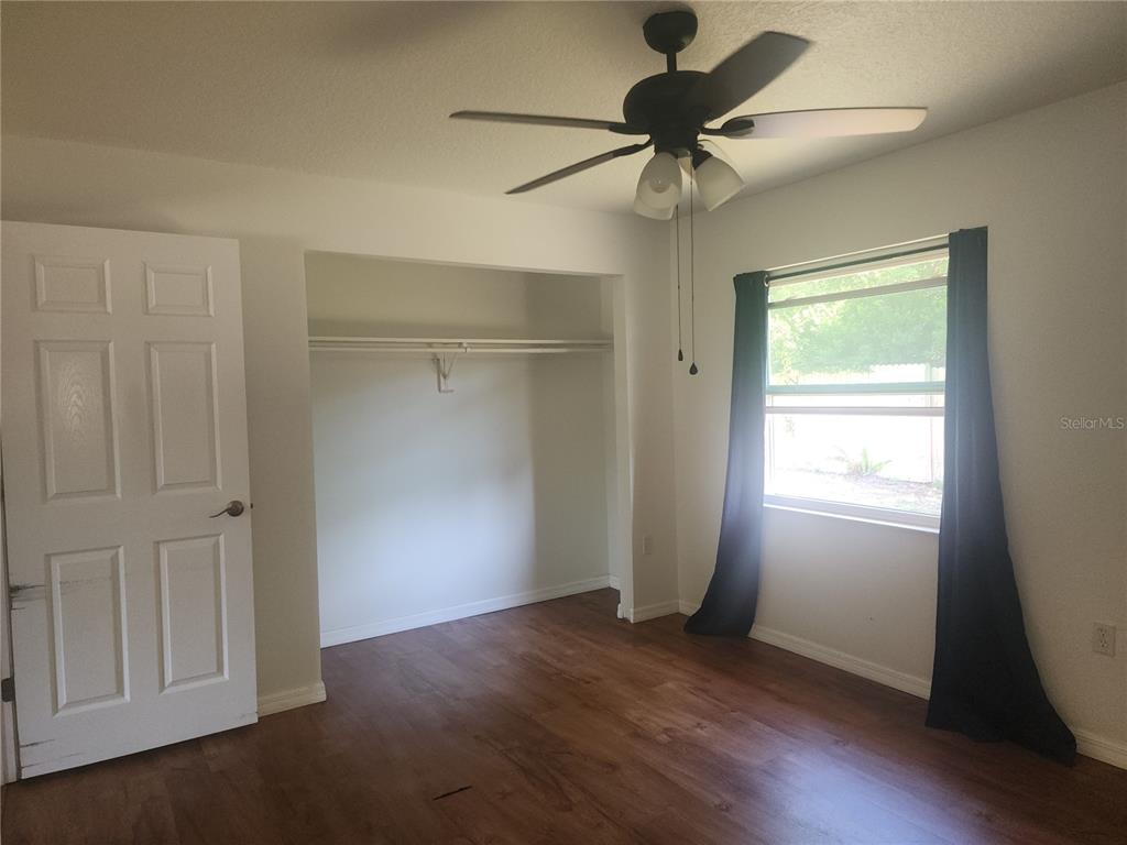 63 Estrella Road DeBary, FL 32713 - Photo 21 of 52 a view of an empty room with a window and wooden floor