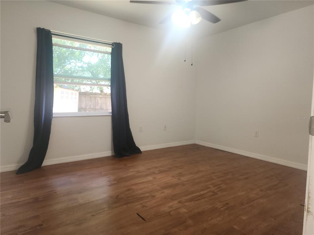63 Estrella Road DeBary, FL 32713 - Photo 28 of 52 an empty room with wooden floor and windows