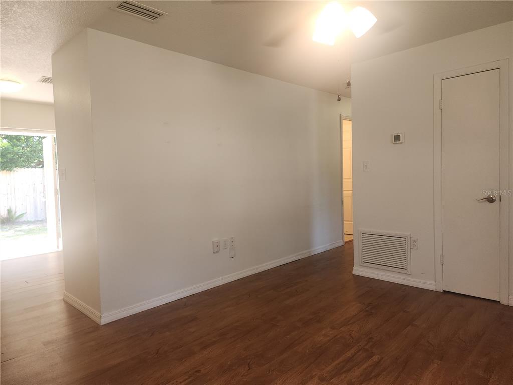 63 Estrella Road DeBary, FL 32713 - Photo 7 of 50 an empty room with wooden floor and windows