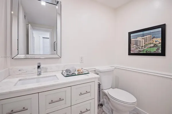 a bathroom with a toilet a sink and mirror