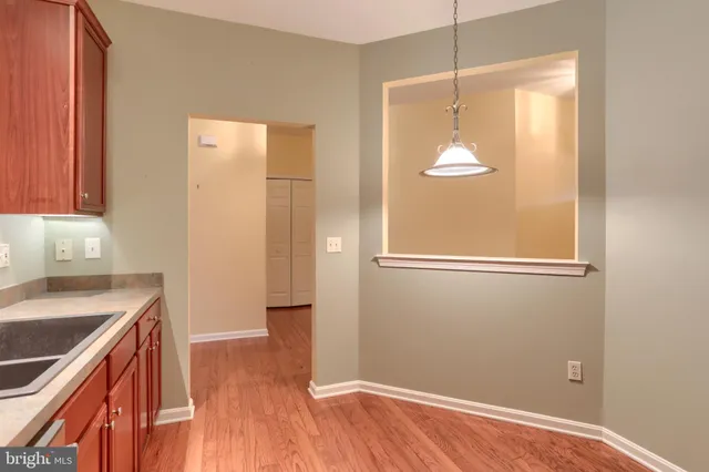 a view of a kitchen with wooden floor and a sink