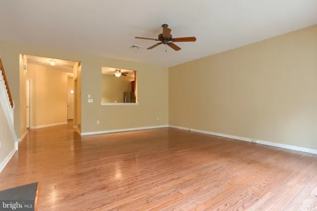 a view of an empty room and wooden floor