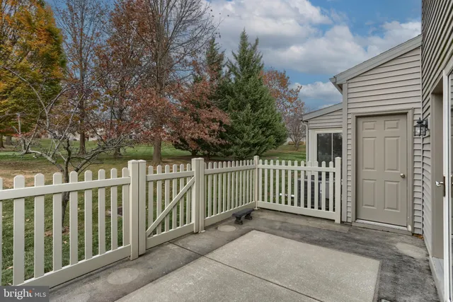 a view of a house with a wooden fence