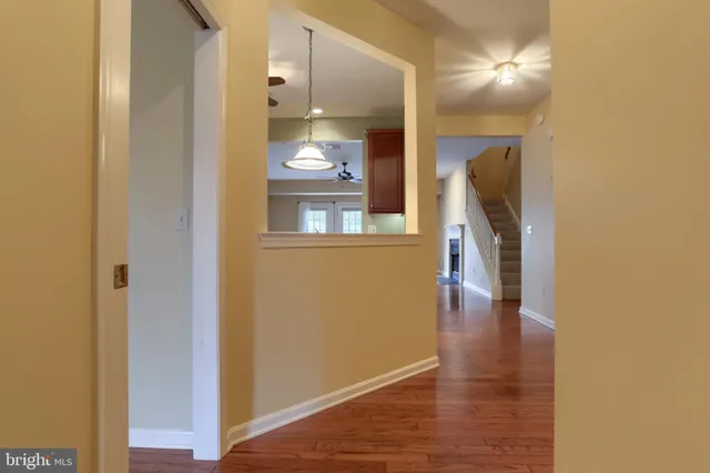 a view of a hallway with wooden floor and furniture