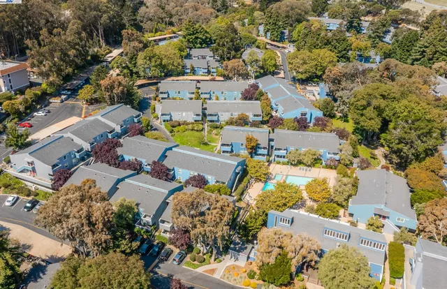 an aerial view of residential houses with outdoor space