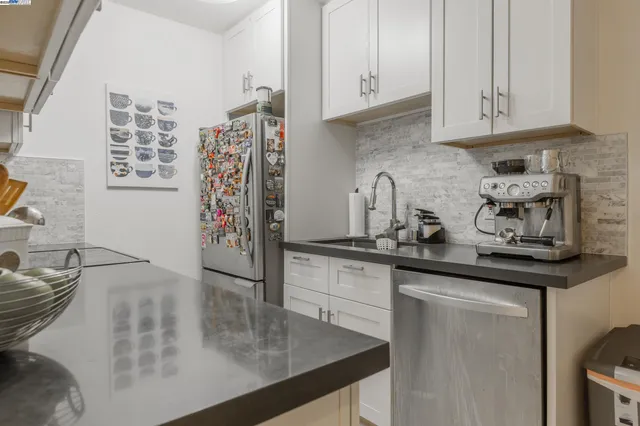 a kitchen with stainless steel appliances granite countertop a sink and cabinets