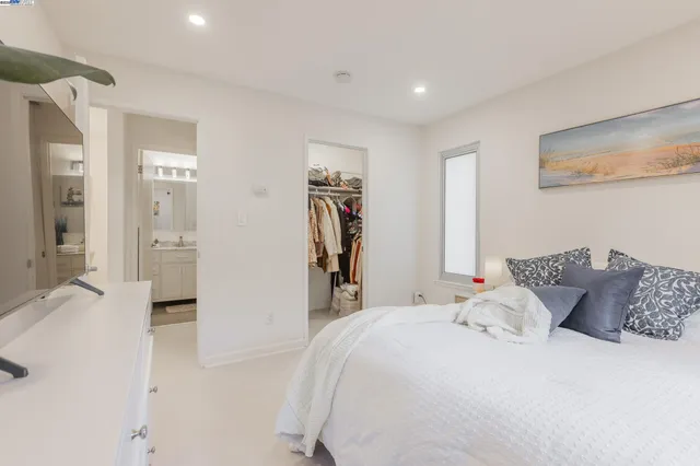 a bedroom with bed and walk in closet