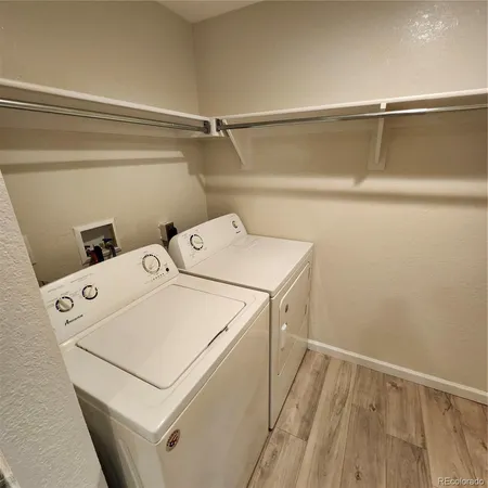 a view of a room with wooden floor