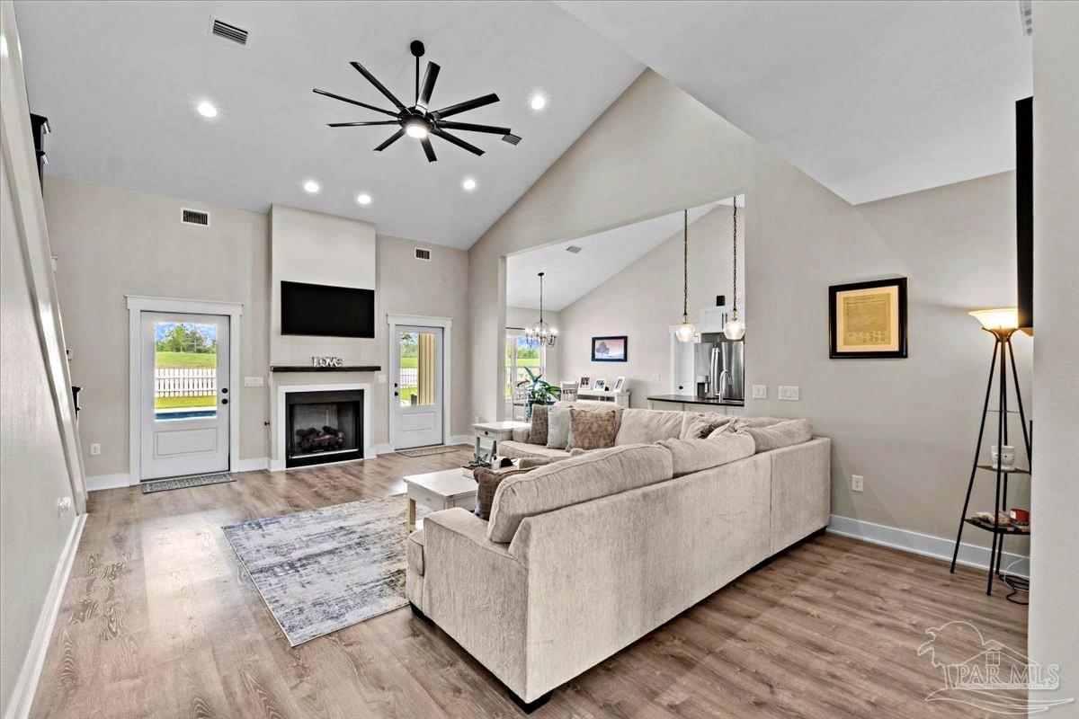 7400 Tidwell Road Pace, FL 32571 - Photo 16 of 36 a living room with furniture and a fireplace