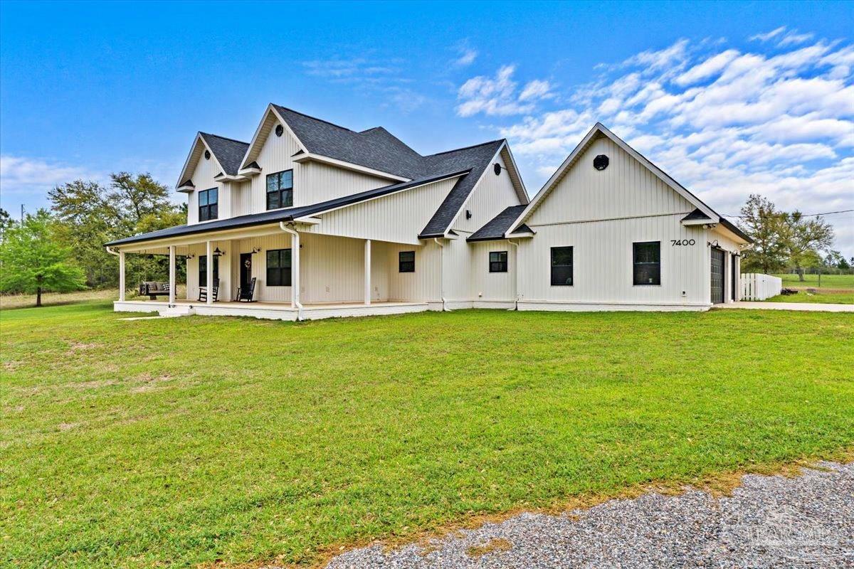 7400 Tidwell Road Pace, FL 32571 - Photo 2 of 36 a front view of a house with garden