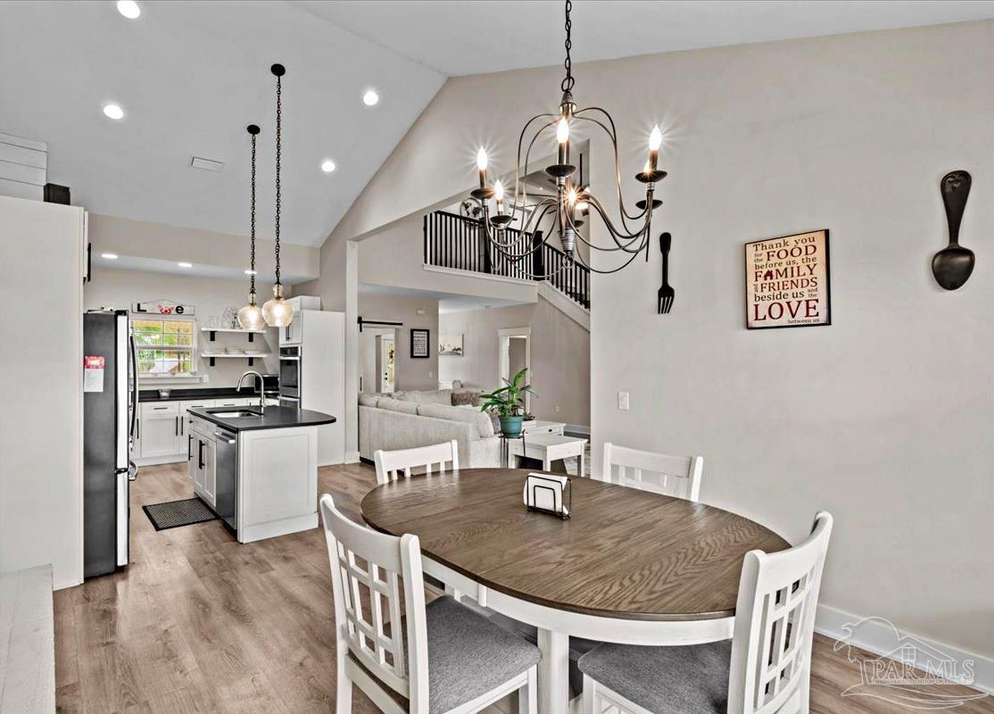 7400 Tidwell Road Pace, FL 32571 - Photo 21 of 36 a kitchen with a dining table and chairs