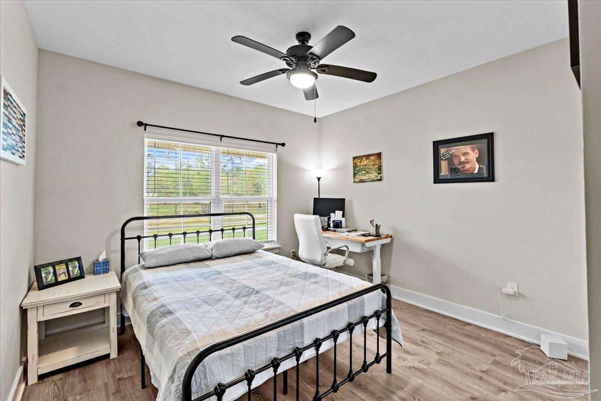 7400 Tidwell Road Pace, FL 32571 - Photo 23 of 36 a bedroom with a bed and a table