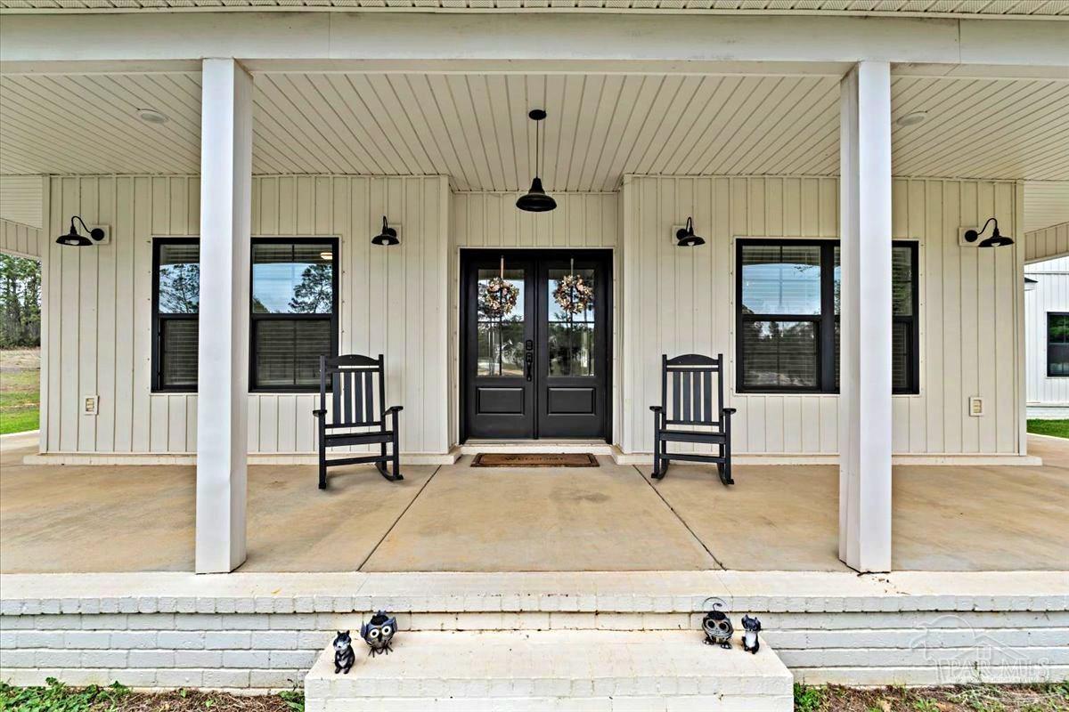 7400 Tidwell Road Pace, FL 32571 - Photo 3 of 36 a front view of a building with glass door