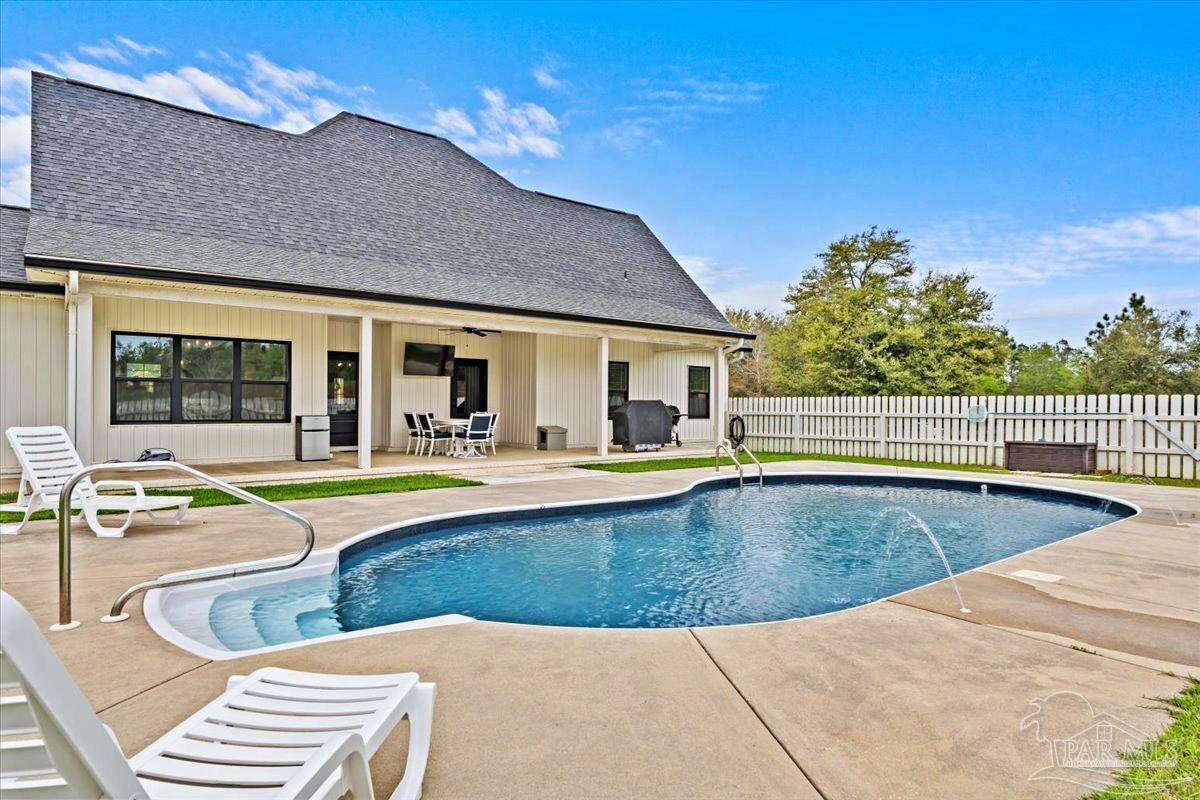 7400 Tidwell Road Pace, FL 32571 - Photo 35 of 36 a view of a house with swimming pool and sitting area