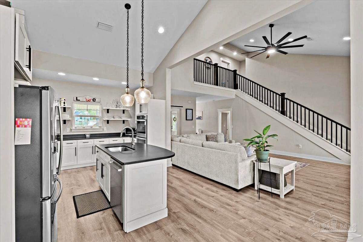 7400 Tidwell Road Pace, FL 32571 - Photo 5 of 36 a living room with furniture and a chandelier