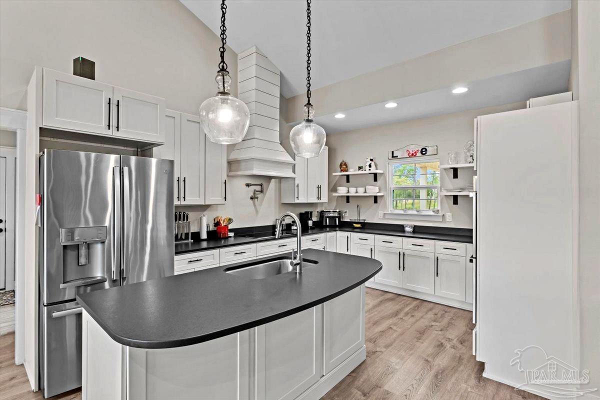 7400 Tidwell Road Pace, FL 32571 - Photo 6 of 36 a kitchen with stainless steel appliances granite countertop a sink a stove and refrigerator