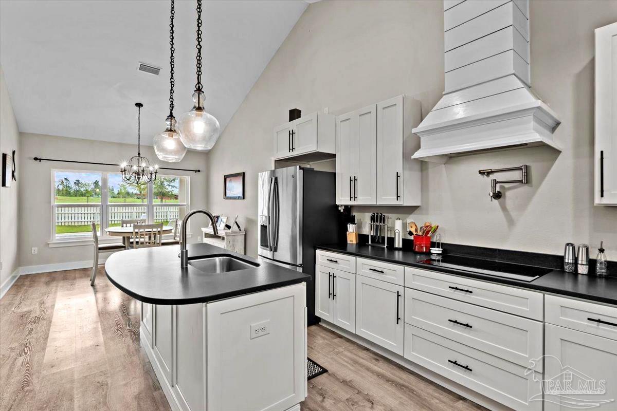 7400 Tidwell Road Pace, FL 32571 - Photo 7 of 36 a kitchen with sink cabinets and window