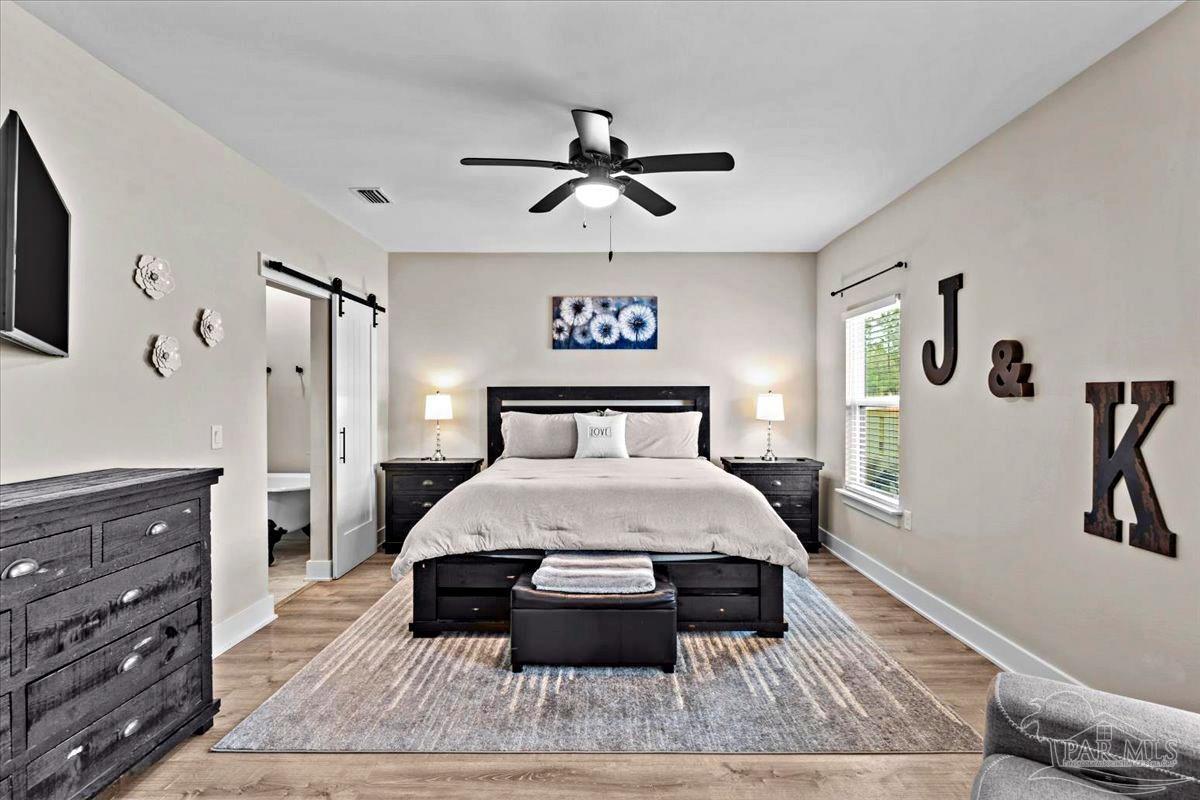 7400 Tidwell Road Pace, FL 32571 - Photo 9 of 36 a spacious bedroom with a bed and a dresser