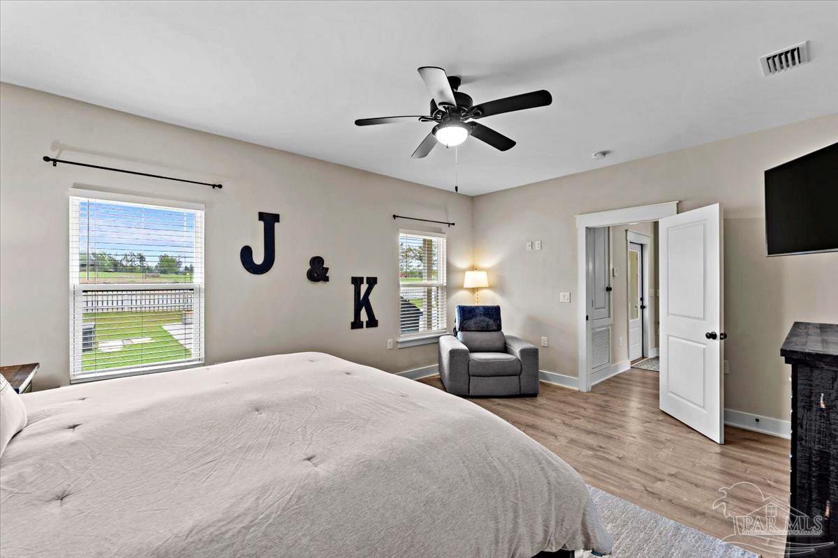 7400 Tidwell Road Pace, FL 32571 - Photo 10 of 36 a bedroom with a bed and wooden floor