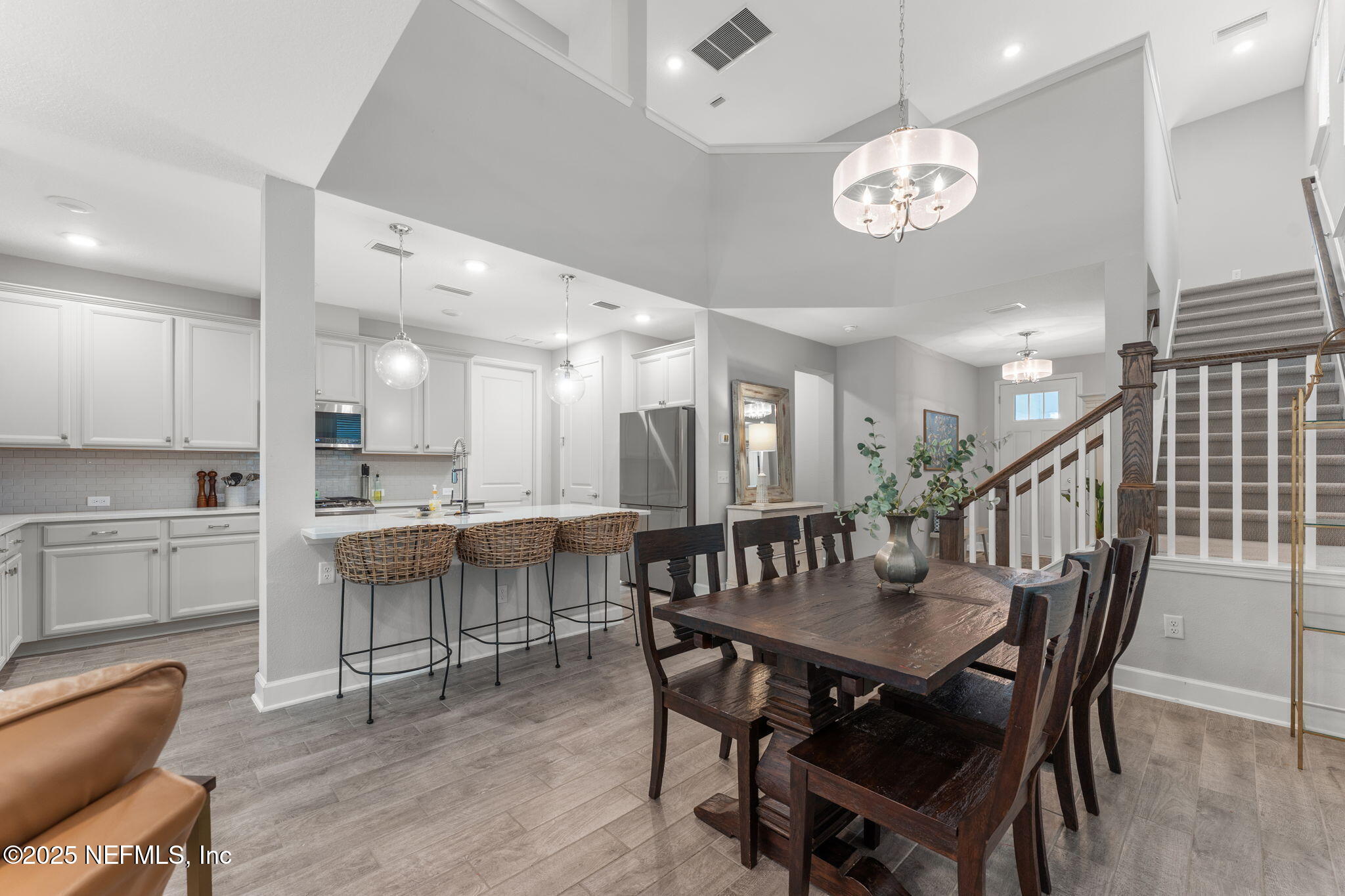 267 Windswept Way St. Augustine, FL 32092 - Photo 13 of 50 a view of a dining room and livingroom with furniture wooden floor a rug a painting