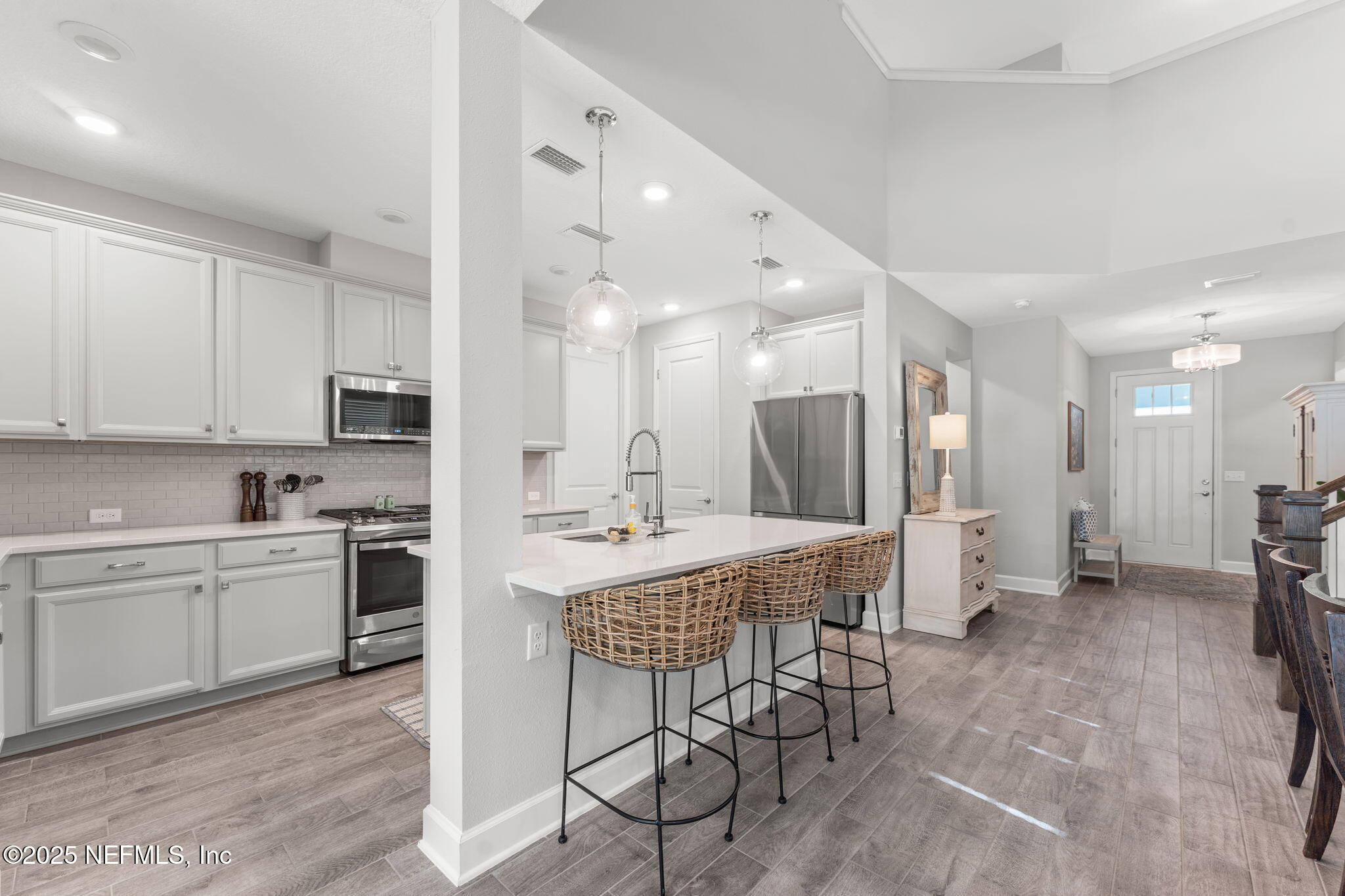 267 Windswept Way St. Augustine, FL 32092 - Photo 14 of 50 a kitchen with stainless steel appliances kitchen island granite countertop a table and chairs in it